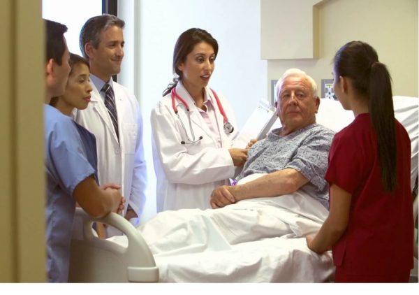 medical staff surrounding patient's beside graphic from stamp & chase