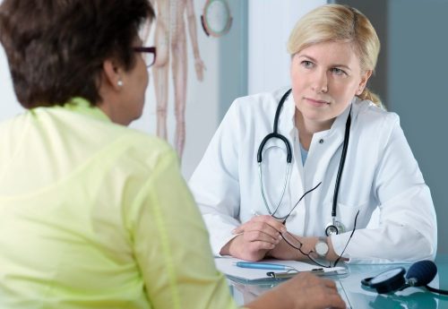 medical employee interviewing patient at stamp & chase